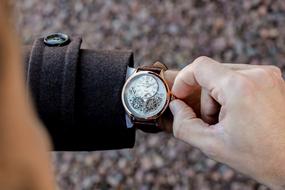 man adjusting watch