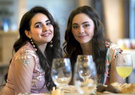 photo of two happy girlfriends in a restaurant