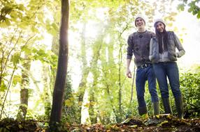 happy young couple in forest at fall