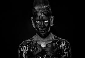 black and white photo of a girl stained with black paint