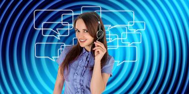 Woman from call center, with headset, at blue and white background with message icons