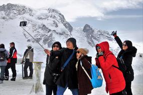 People, taking selfie on the beautiful, snowy mountain in Zermatt, Switzerland