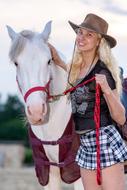 photo of a girl next to a white horse