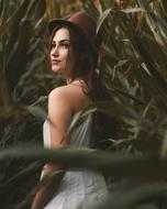 young Girl in red hat at greenery