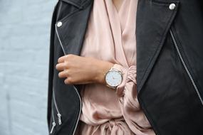 Woman with the black stylish leather jacket and wrist watch