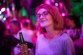 photo of a girl at a party under pink light