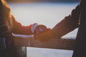man and woman in warm mittens
