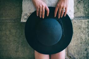 black hat in female hands