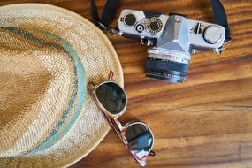 the camera near the hat with glasses