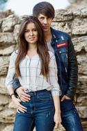 photo of a romantic couple on a stone wall background