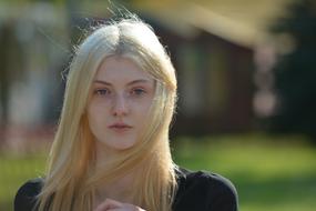 blonde in nature on a blurred background