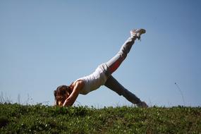 Sport Yoga on the green grass on a sunny day