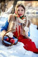 beautiful girl in folk costume in the snow