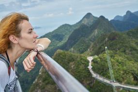 woman looks at the mountains from the observation deck