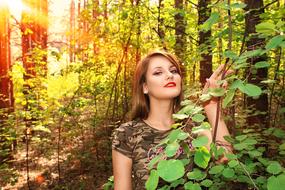 lovely young woman posing in forest