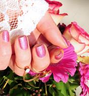 girl's hand with manicure and a bouquet of roses