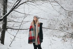 young woman in snowy forest