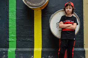 sportive child Boy posing at painted wall