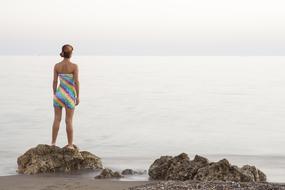 girl in a striped dress on the ocean
