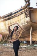 girl on the background of a wooden ship