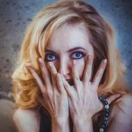 scared adult Woman with hands at face