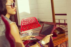 stylish Woman in Sunglasses sits at table