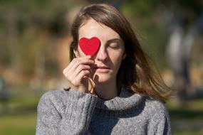 Valentineâs Day Celebration, girl with heart in hand at eye