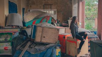photo of a girl in a cluttered room