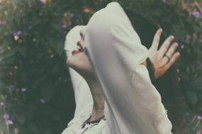 girl posing in profile on a blurred background