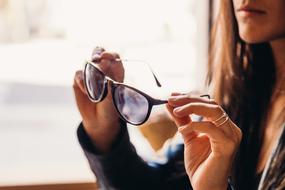Girl holding sunglasses in her hands