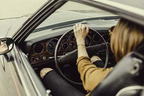 Woman, driving the car with dashboard inside