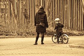 Mother and Child boy with bicycle outdoor