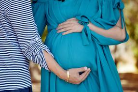 man touching baby bump