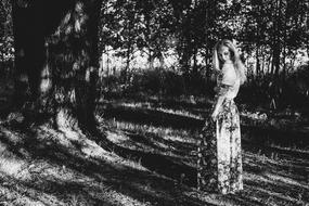 young girl in summer forest in black and white background