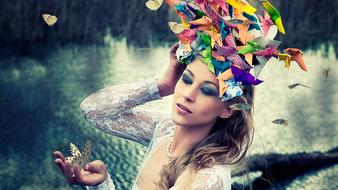 Portrait of the beautiful woman with make-up with colorful shapes, near the water in light