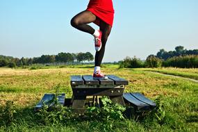 woman doing Yoga exercise at table top at scenic landscape