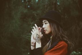 photo of asian girl with tattoo in black hat