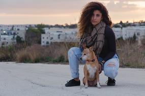 beautiful woman with brown dog at dusk