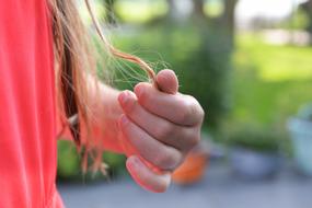 a lock of hair in the girl's hand