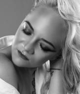 Black and white portrait of the posing woman with closed eyes