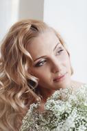 posing blonde with flower bouquet