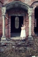 girl in white at a photo shoot near an abandoned house