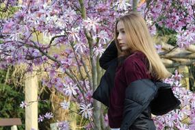young blonde in spring garden