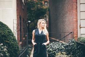 stylish blonde posing near buildings