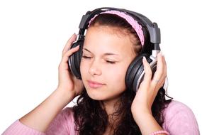 Portrait of the cute girl, with the headphones, listening to headphones, at white background