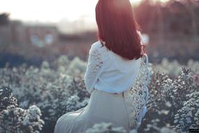 woman among flowers in the evening light