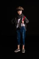 teenager in fashionable clothes on a black background