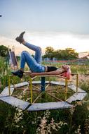 the girl lies on the children's carousel