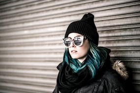young woman with blue hair and black hat