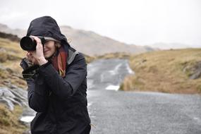woman on the road with camera